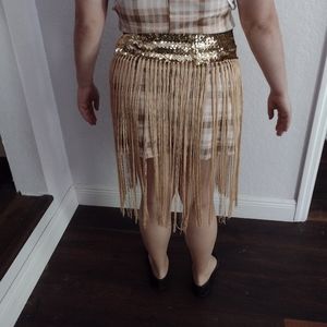 A gold fringed skirt with gold sequins